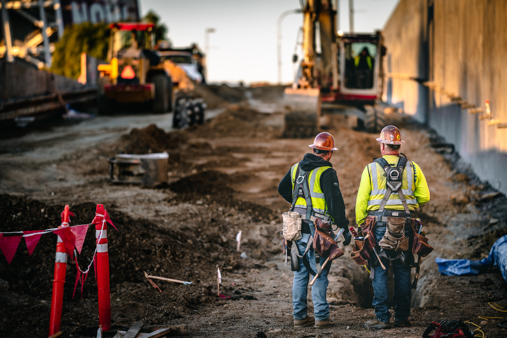 Two workers looking over a construction project